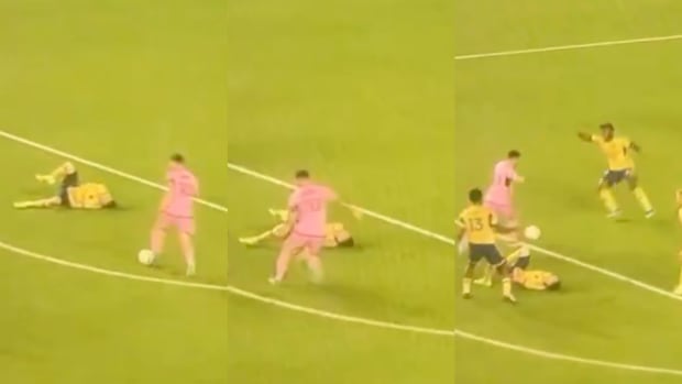 Inter Miami captain Lionel Messi pictured (in pink) dribbling past Real Salt Lake defender Andrew Brody while he is lying on the ground during the opening game of the 2024 MLS season